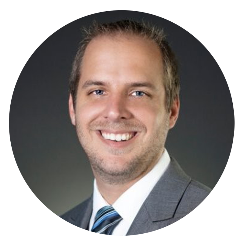 Man in a suit smiling at the camera.